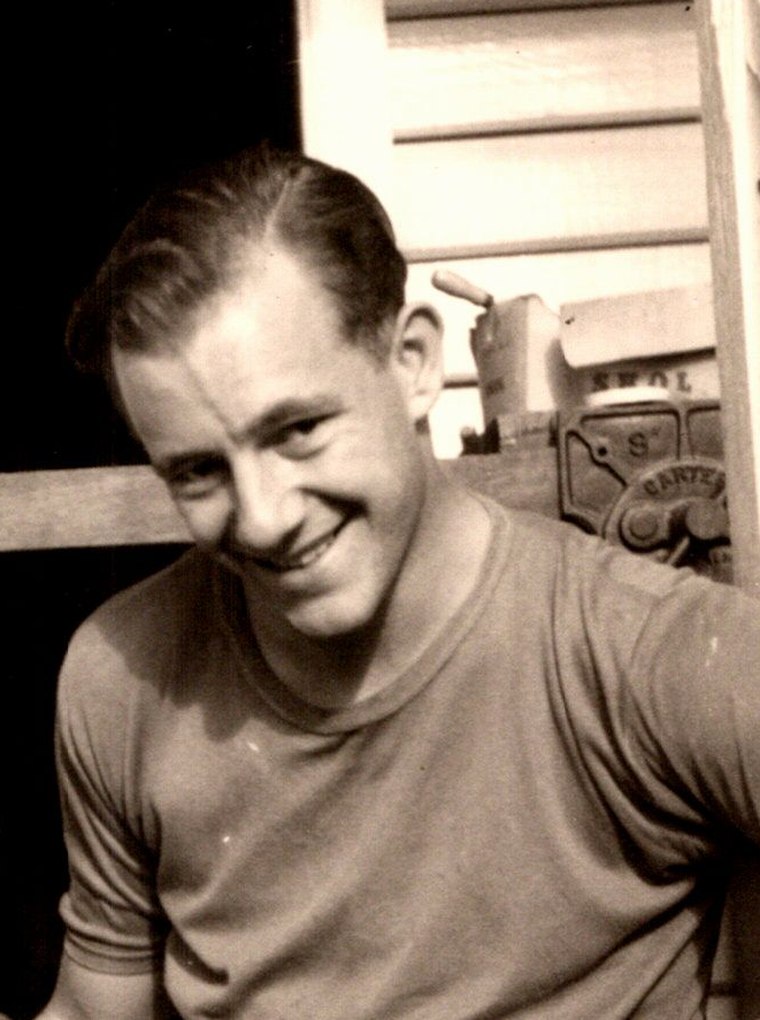 Derek Distel, smiling, on the steps of the house at Richmond in 1965