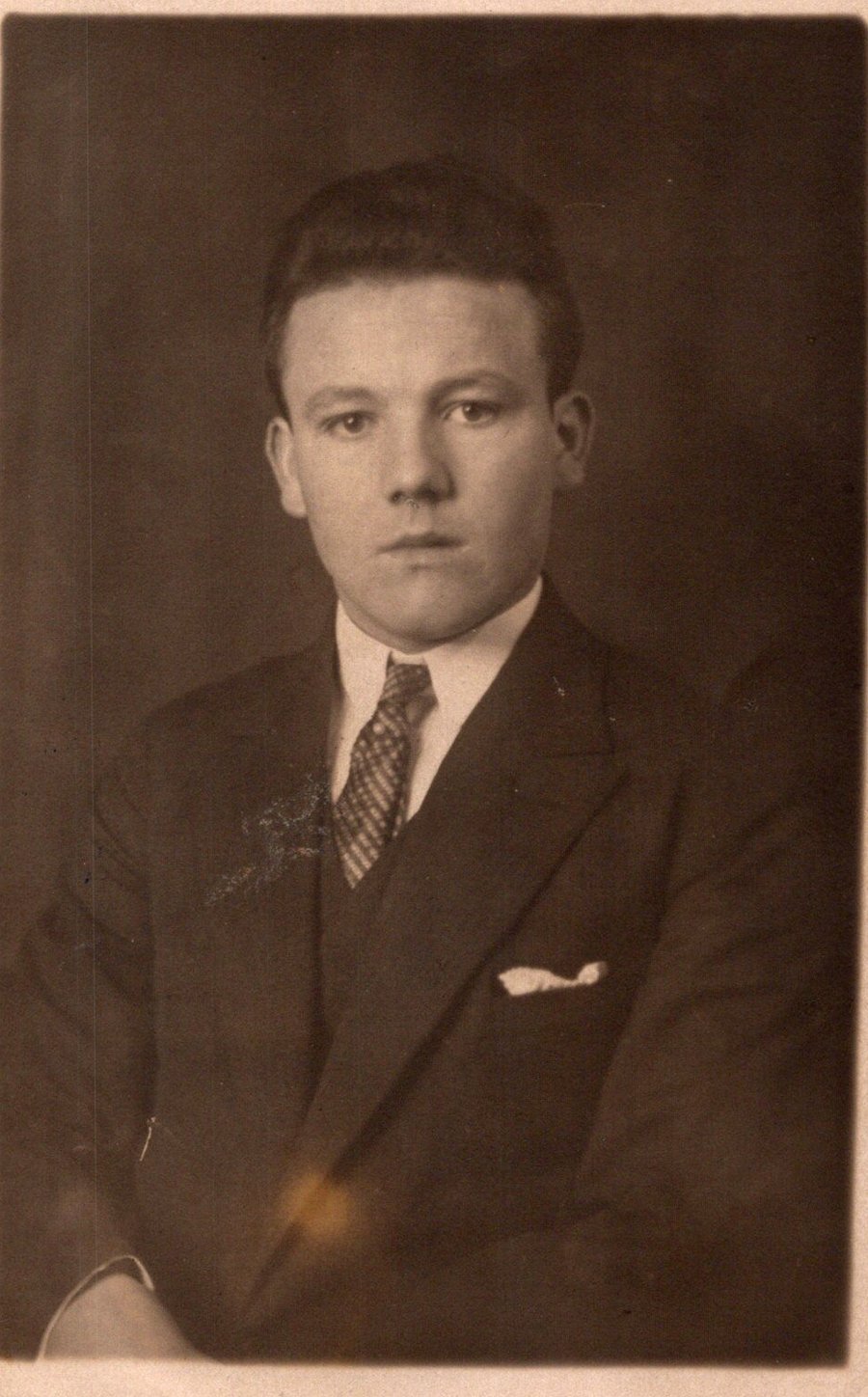 Studio portrait of Willi Distel as a young man in a dark suit, about 1925